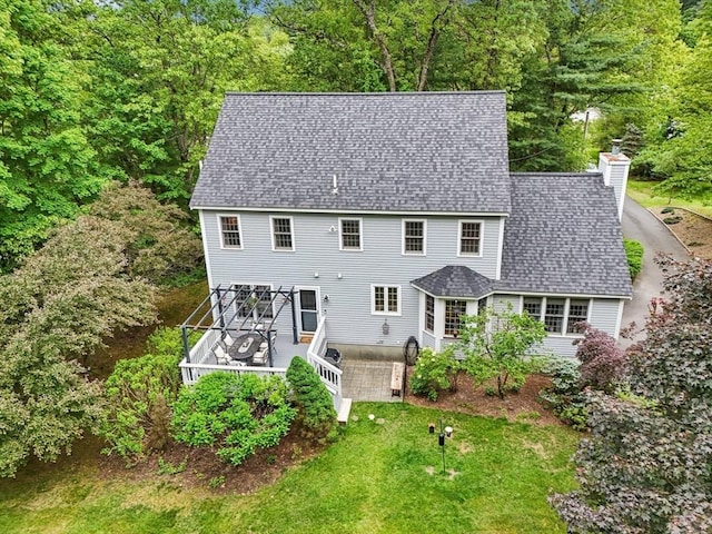 176 Crescent St, Stow, MA 01775 - back of property with a deck, a chimney, and a shingled roof