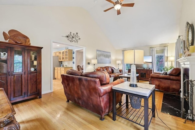 176 Crescent St, Stow, MA 01775 - living area featuring high vaulted ceiling, a ceiling fan, light wood finished floors, and a fireplace