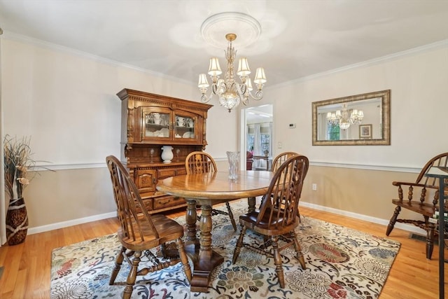 176 Crescent St, Stow, MA 01775 - dining room featuring a chandelier, light wood-style flooring, ornamental molding, and baseboards