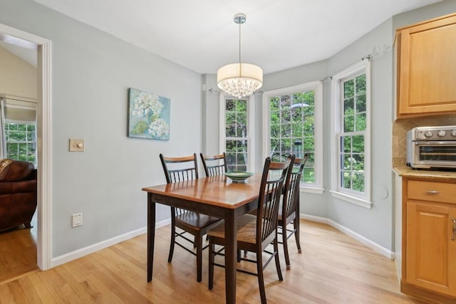 176 Crescent St, Stow, MA 01775 - dining room featuring light wood finished floors, a chandelier, plenty of natural light, and baseboards