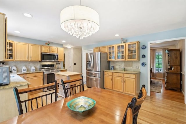 176 Crescent St, Stow, MA 01775 - dining area featuring light wood-type flooring, recessed lighting, and a chandelier