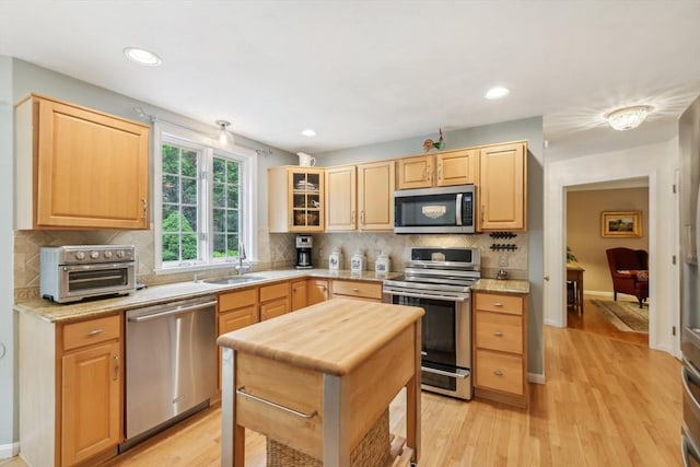 176 Crescent St, Stow, MA 01775 - kitchen featuring appliances with stainless steel finishes, a sink, light brown cabinetry, tasteful backsplash, and recessed lighting