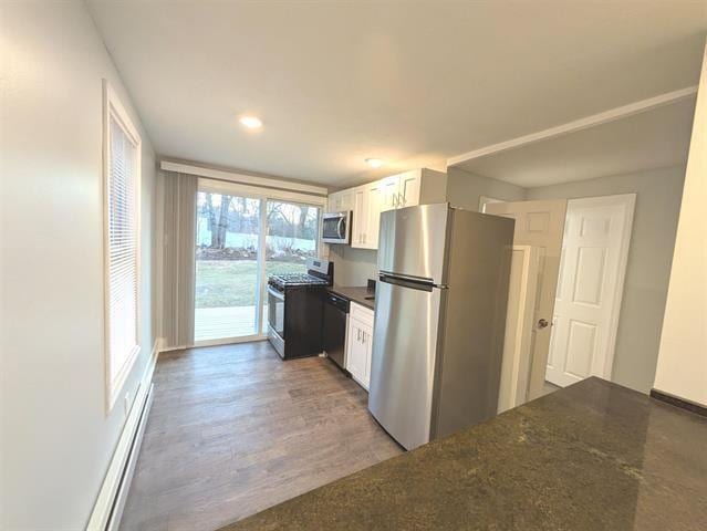 3 S Shore Rd, Salem, NH 03079 - kitchen with appliances with stainless steel finishes, white cabinetry, wood finished floors, and dark stone counters