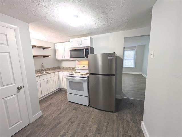 3 S Shore Rd, Salem, NH 03079 - kitchen with stainless steel appliances, a textured ceiling, white cabinetry, dark wood-style flooring, and open shelves
