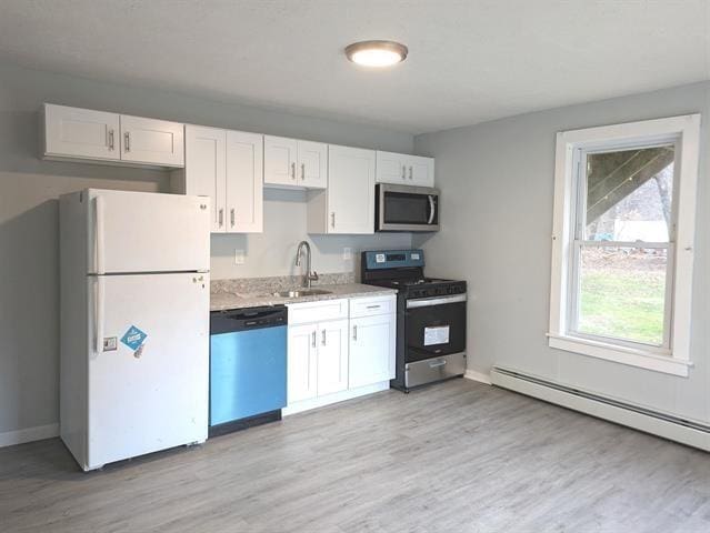 3 S Shore Rd, Salem, NH 03079 - kitchen with appliances with stainless steel finishes, white cabinetry, light wood-type flooring, a baseboard heating unit, and light stone countertops
