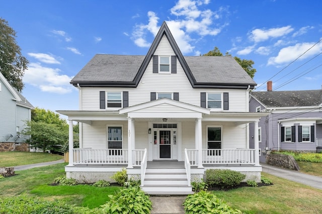 view of front of home featuring a front lawn and covered porch