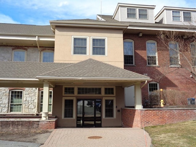 12 Brookside Rd Unit 20, Westford, MA 01886 - view of front of property with a shingled roof and stucco siding