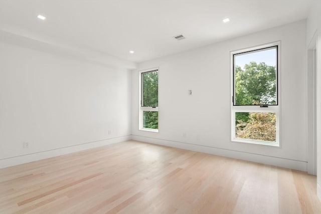 spare room featuring light hardwood / wood-style flooring