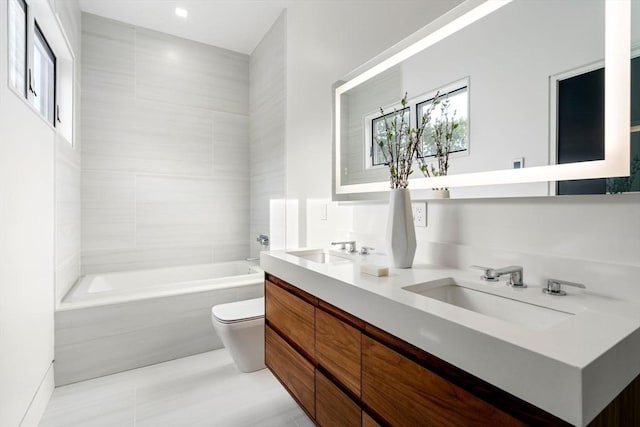 bathroom with vanity, a bath, tile patterned floors, and toilet