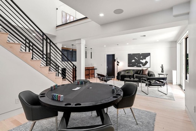 playroom featuring a wealth of natural light, light hardwood / wood-style flooring, and ornate columns