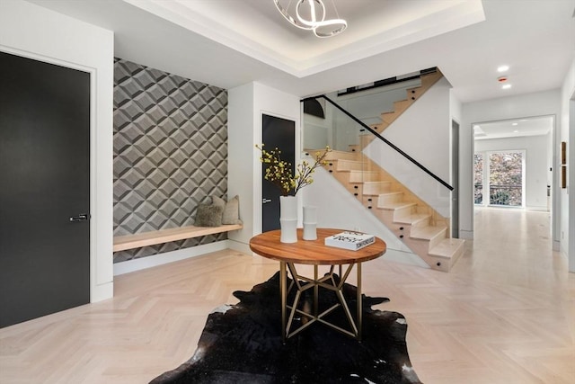 interior space featuring light parquet flooring, a barn door, and a raised ceiling