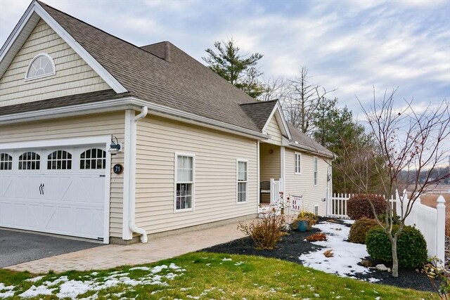 view of side of property with a garage