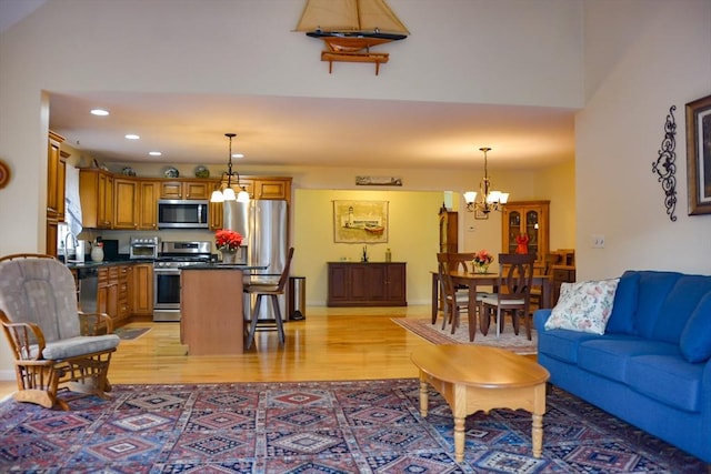 living room featuring a notable chandelier and light hardwood / wood-style flooring