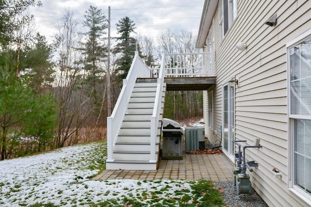 snow covered patio with area for grilling