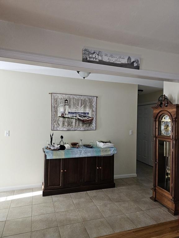 bar featuring dark brown cabinetry and light tile patterned floors