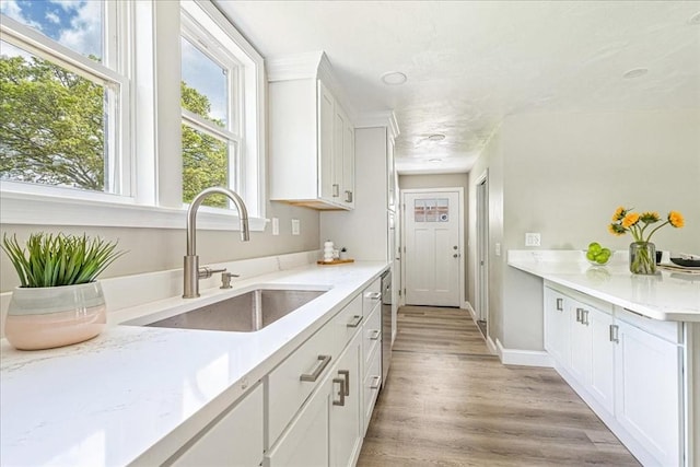 1009 Point Rd, Marion, MA 02738 - kitchen featuring a sink, light wood finished floors, white cabinetry, and baseboards