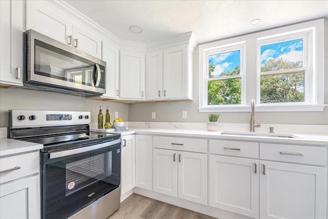 1009 Point Rd, Marion, MA 02738 - kitchen featuring stainless steel appliances, a sink, light countertops, and white cabinets