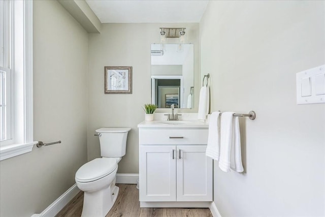 1009 Point Rd, Marion, MA 02738 - bathroom featuring toilet, vanity, wood finished floors, and baseboards