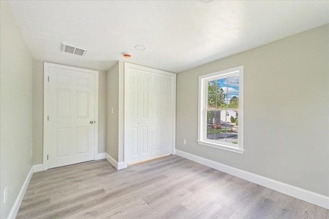 1009 Point Rd, Marion, MA 02738 - unfurnished bedroom with light wood-style flooring, a closet, and baseboards