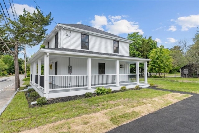 1009 Point Rd, Marion, MA 02738 - country-style home featuring a porch, a front lawn, and roof with shingles