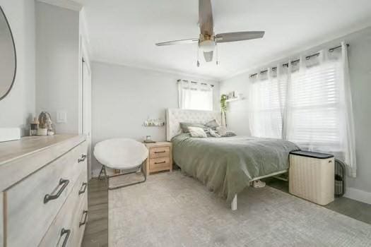 bedroom with light hardwood / wood-style floors and ceiling fan