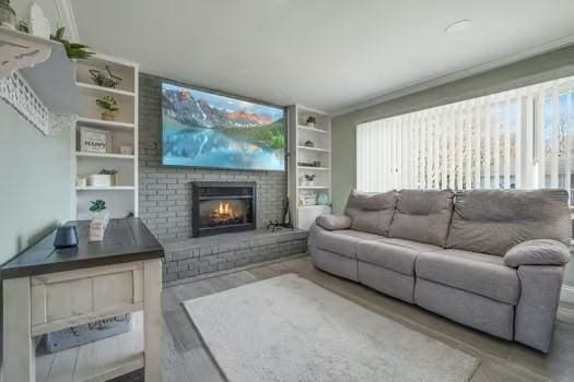 living room with hardwood / wood-style floors and a fireplace