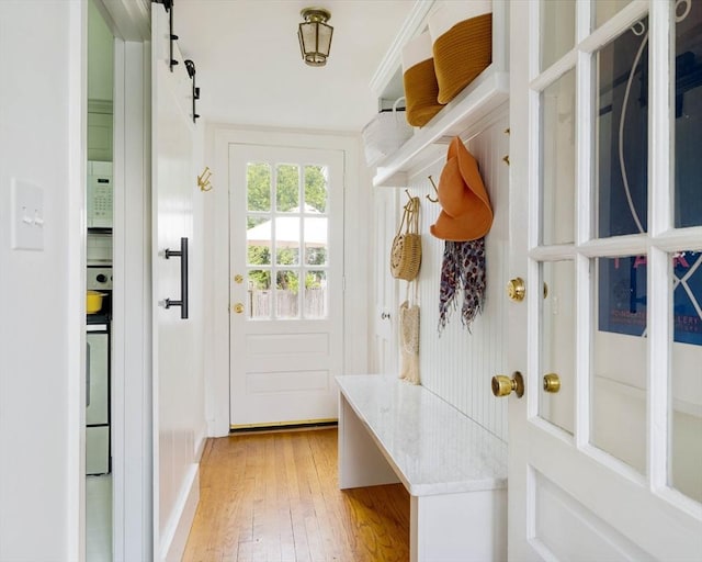 mudroom with light wood-style floors