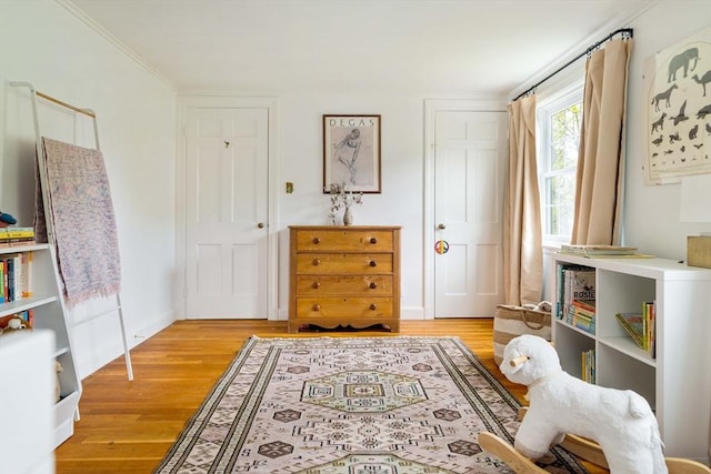 interior space with ornamental molding and light wood-style floors