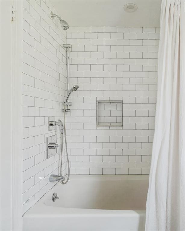 bathroom with shower / tub combo with curtain