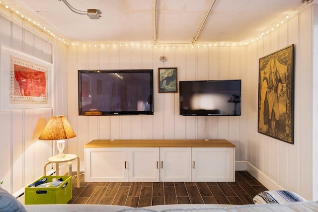 living area featuring baseboards and wood tiled floor