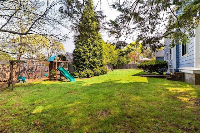 view of yard with a fenced backyard and a playground