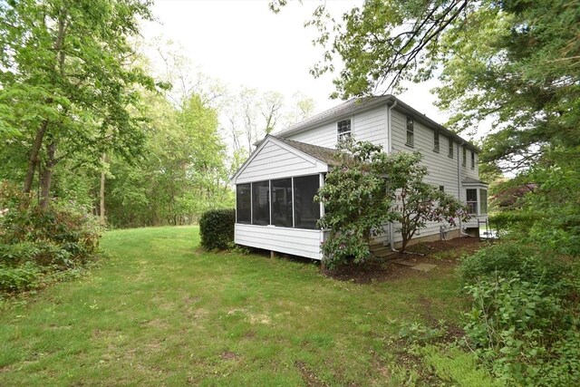 83 Cider Mill Rd, Sudbury, MA 01776 - view of home's exterior featuring a sunroom and a lawn