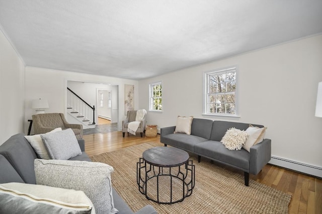 83 Cider Mill Rd, Sudbury, MA 01776 - living area with wood finished floors, stairway, and a baseboard radiator