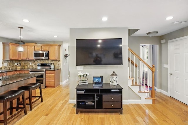21 Rose Ln, Uxbridge, MA 01569 - living room with light wood-style floors, stairway, baseboards, and recessed lighting