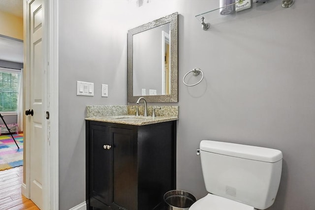 21 Rose Ln, Uxbridge, MA 01569 - half bath with vanity, toilet, wood finished floors, and baseboards