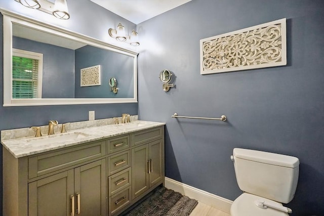 21 Rose Ln, Uxbridge, MA 01569 - bathroom featuring toilet, double vanity, and baseboards