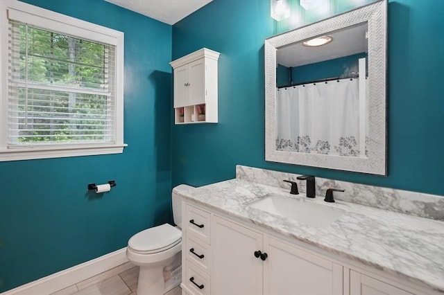 21 Rose Ln, Uxbridge, MA 01569 - bathroom with toilet, vanity, healthy amount of natural light, and baseboards