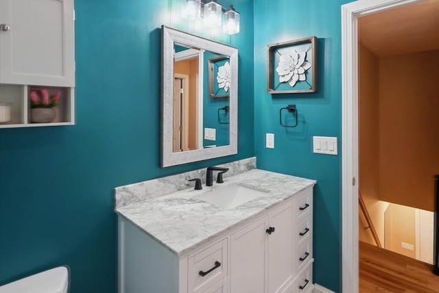 21 Rose Ln, Uxbridge, MA 01569 - half bathroom with toilet, vanity, and wood finished floors
