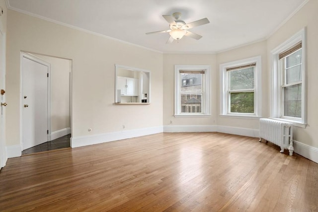 369 Tappan St Unit 8, Brookline, MA 02445 - spare room with radiator, wood finished floors, ceiling fan, and ornamental molding
