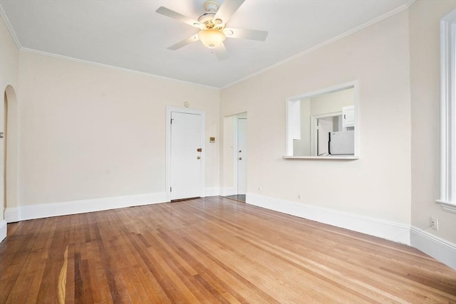 369 Tappan St Unit 8, Brookline, MA 02445 - spare room featuring wood finished floors, a ceiling fan, crown molding, and arched walkways