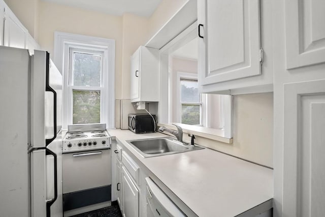 369 Tappan St Unit 8, Brookline, MA 02445 - kitchen with white appliances, white cabinets, and light countertops