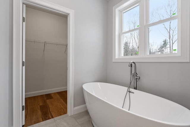 bathroom with tile patterned flooring and a bathtub