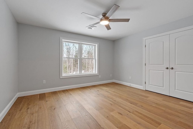 unfurnished bedroom featuring light hardwood / wood-style flooring, a closet, and ceiling fan