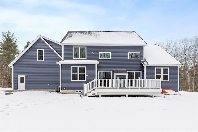 snow covered house with a wooden deck