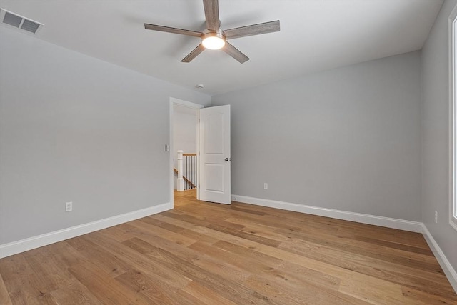 spare room featuring light wood-type flooring and ceiling fan