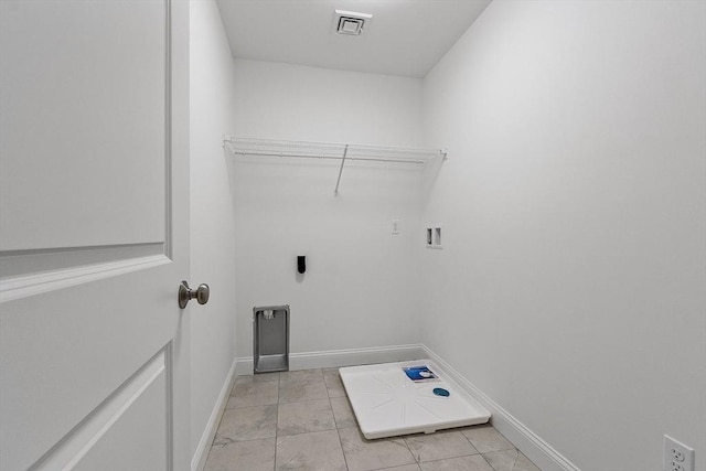 clothes washing area featuring light tile patterned flooring, washer hookup, and hookup for an electric dryer