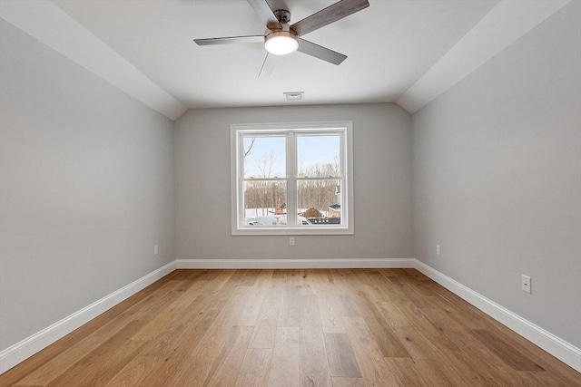 empty room featuring ceiling fan, light hardwood / wood-style flooring, and lofted ceiling