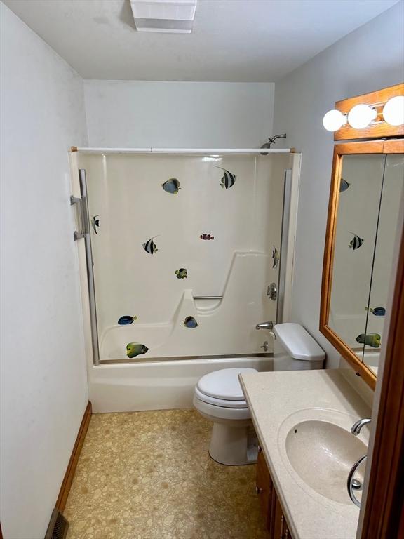 full bathroom with shower / tub combination, vanity, and toilet