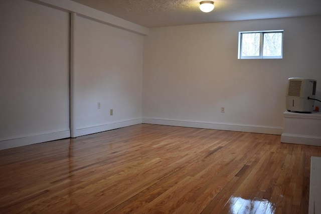 spare room with hardwood / wood-style floors and a textured ceiling