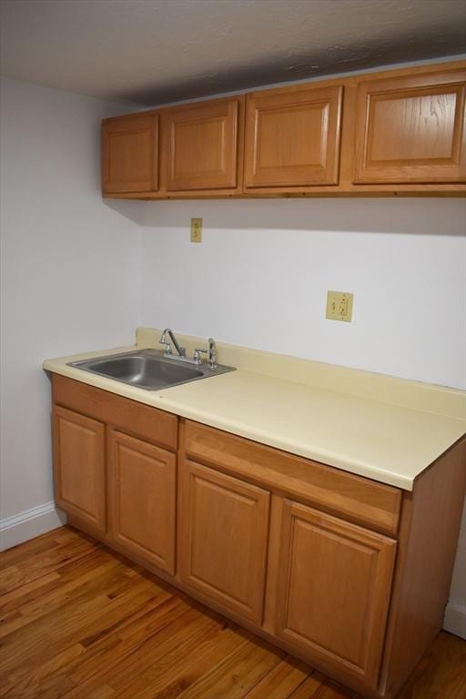 kitchen with sink and light hardwood / wood-style flooring